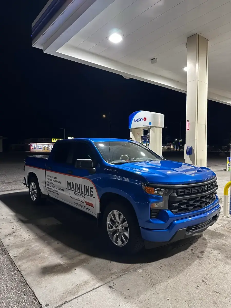 Mainline Plumbing Chevy service truck at a South Bay fuel stop