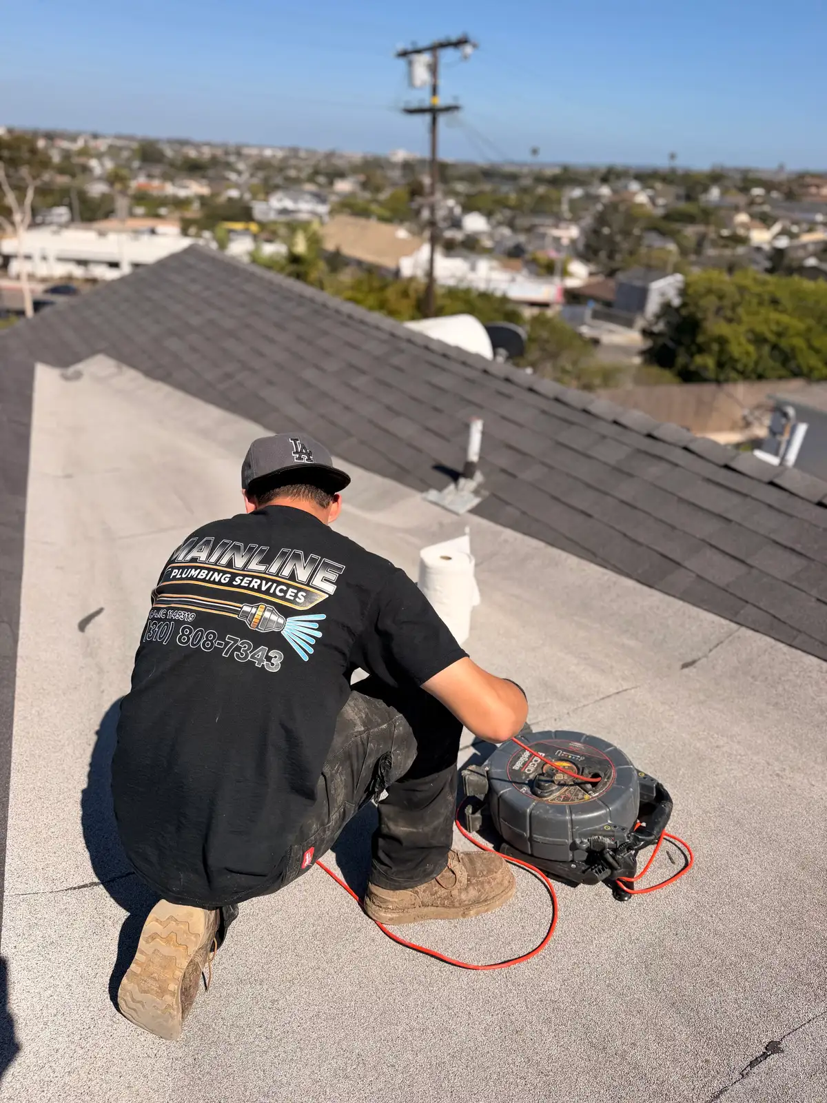 Mainline technician running a sewer camera inspection on a residential lateral