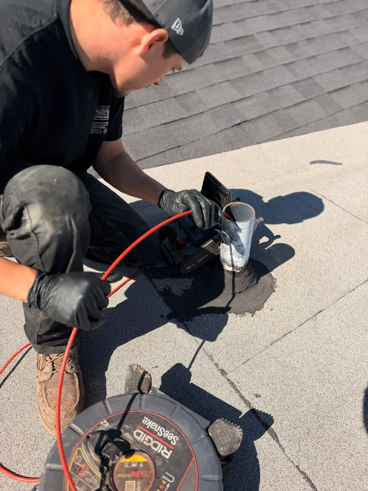 Sewer inspection camera reel fed into a residential drain line