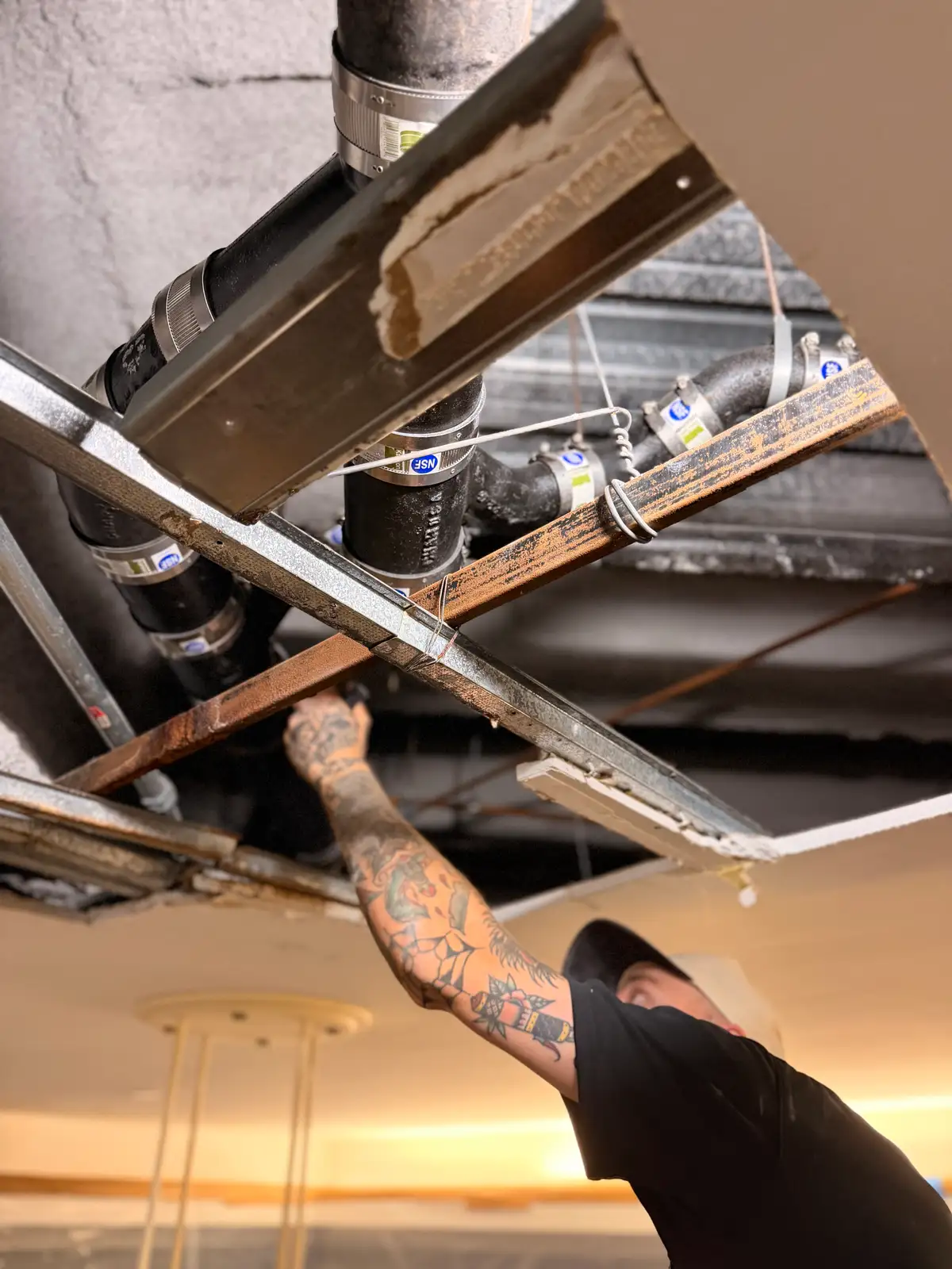 Mainline Plumbing replacing overhead cast iron drain piping on a South Bay commercial job