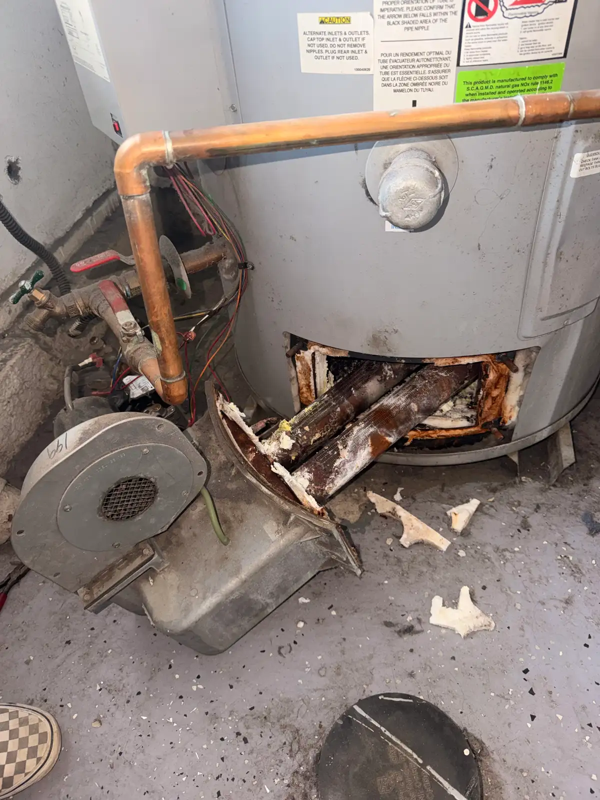 Corroded old commercial water heater removed by Mainline Plumbing during a South Bay replacement, showing years of scale and rust before the new unit goes in