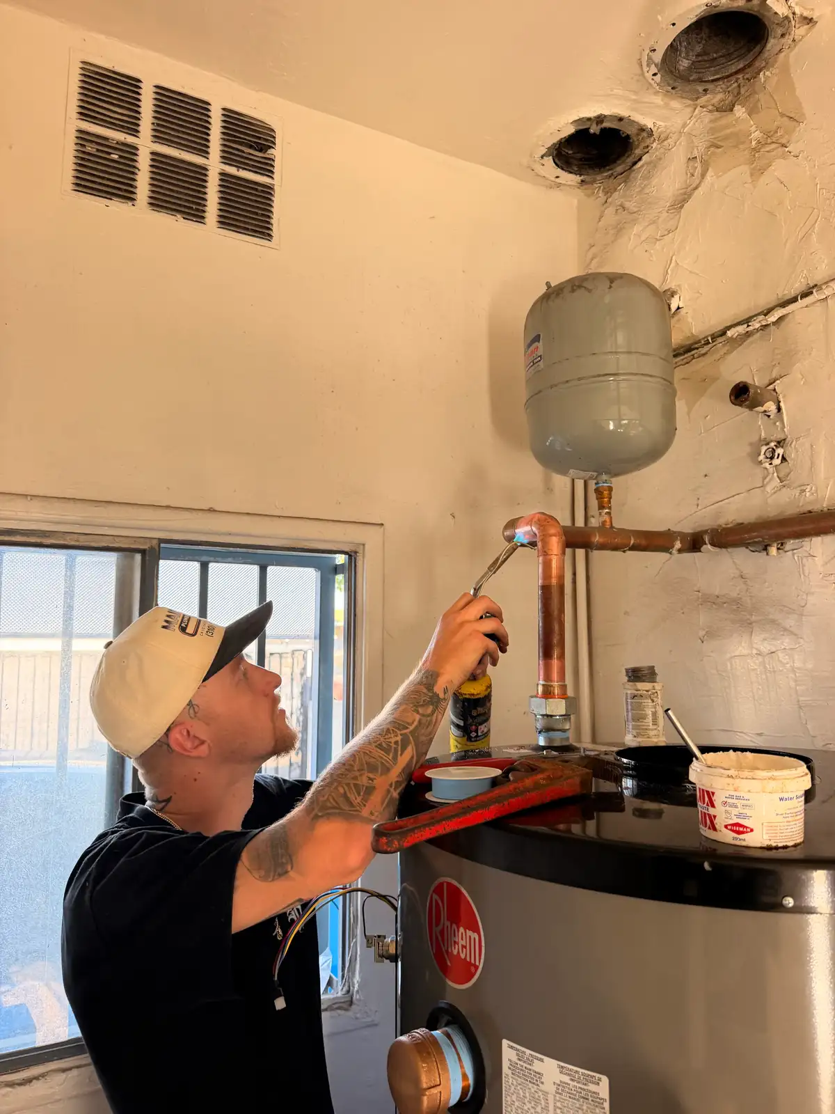 Mainline Plumbing technician repairing a copper water line in a South Bay home, sweating a new soldered copper joint to replace a corroded section