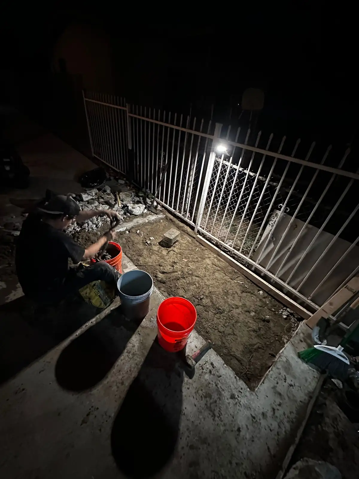 Mainline crew working an emergency plumbing repair after dark
