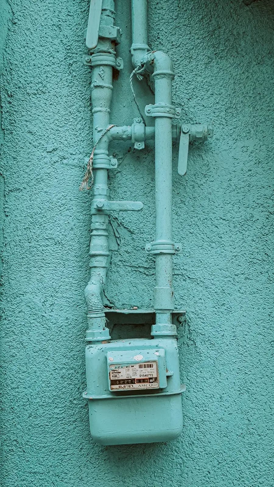 Gas meter and service piping at the exterior of a South Bay home