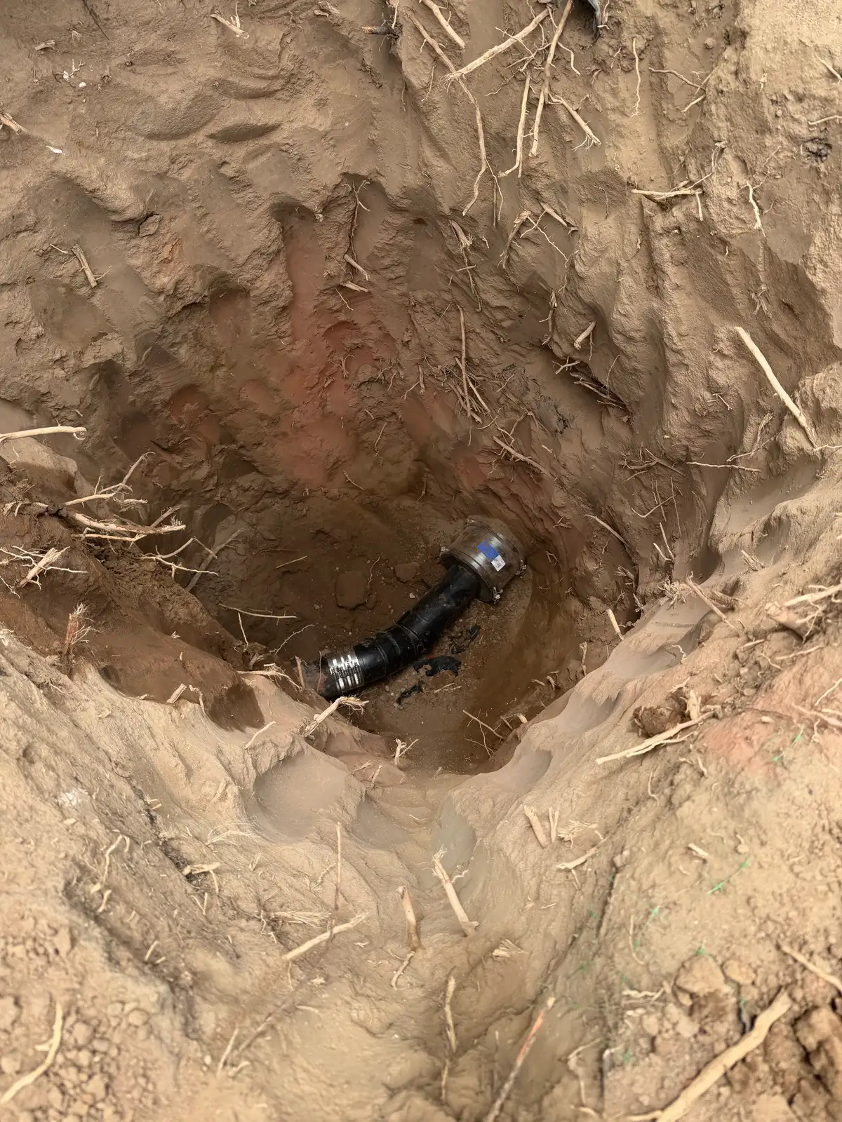 Compact trenchless access pit opened in a South Bay front yard for a sewer lateral replacement