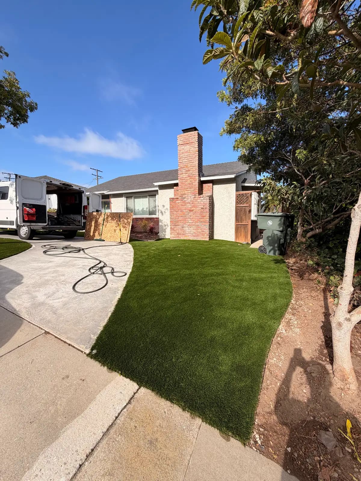 Restored South Bay front yard with intact turf and driveway after a Mainline Plumbing trenchless sewer replacement showing no sign of digging